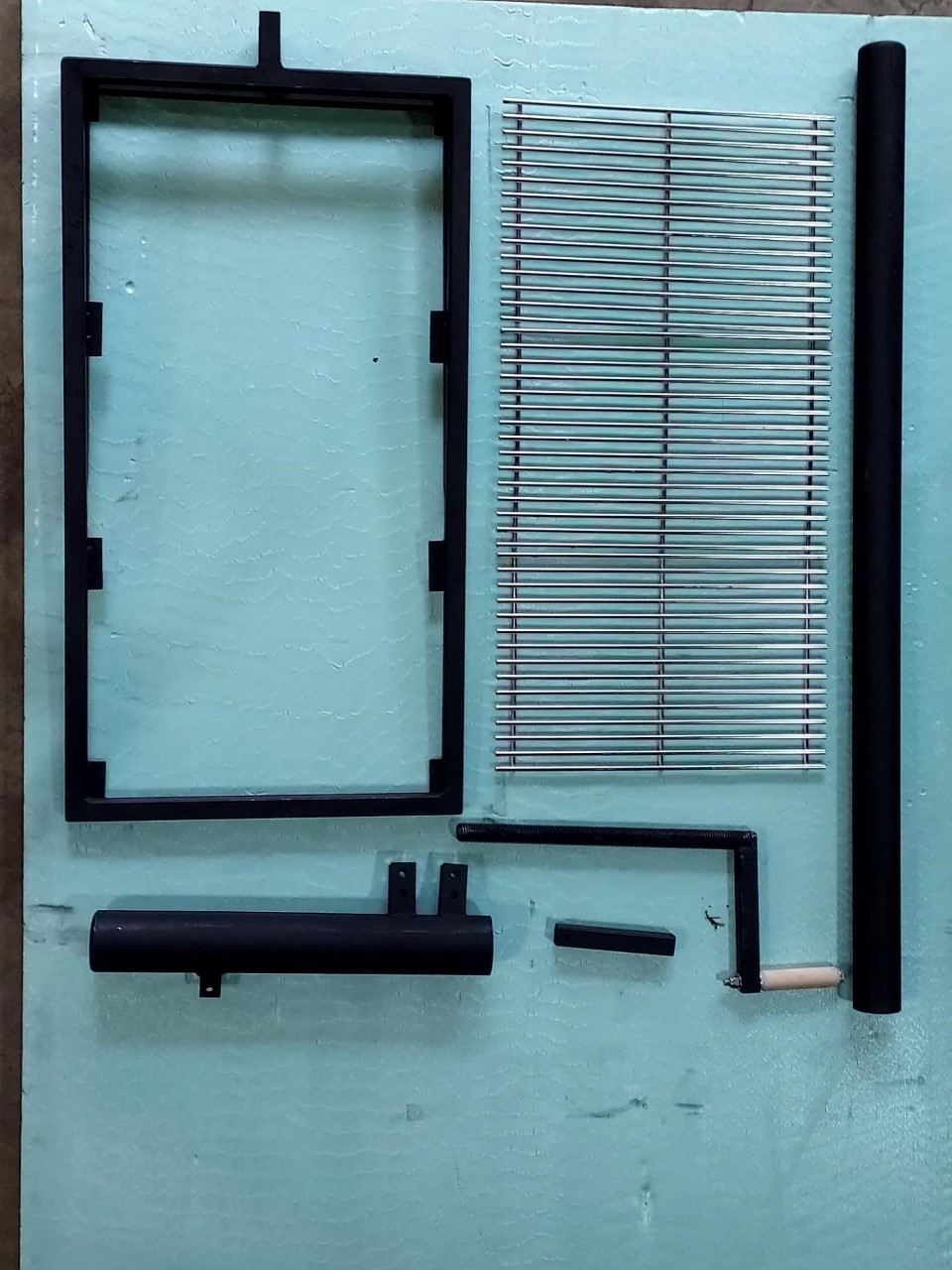 Unassembled grill on white background.